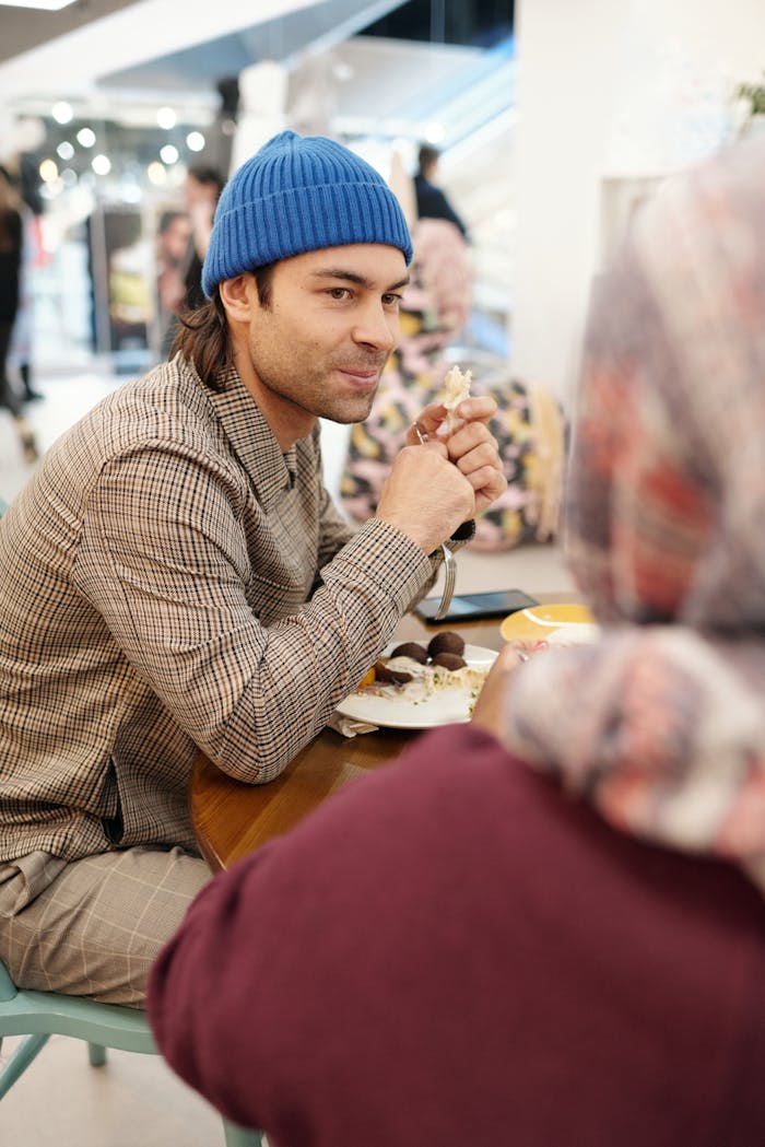 A relaxed dining moment with friends enjoying food in a cozy café environment.